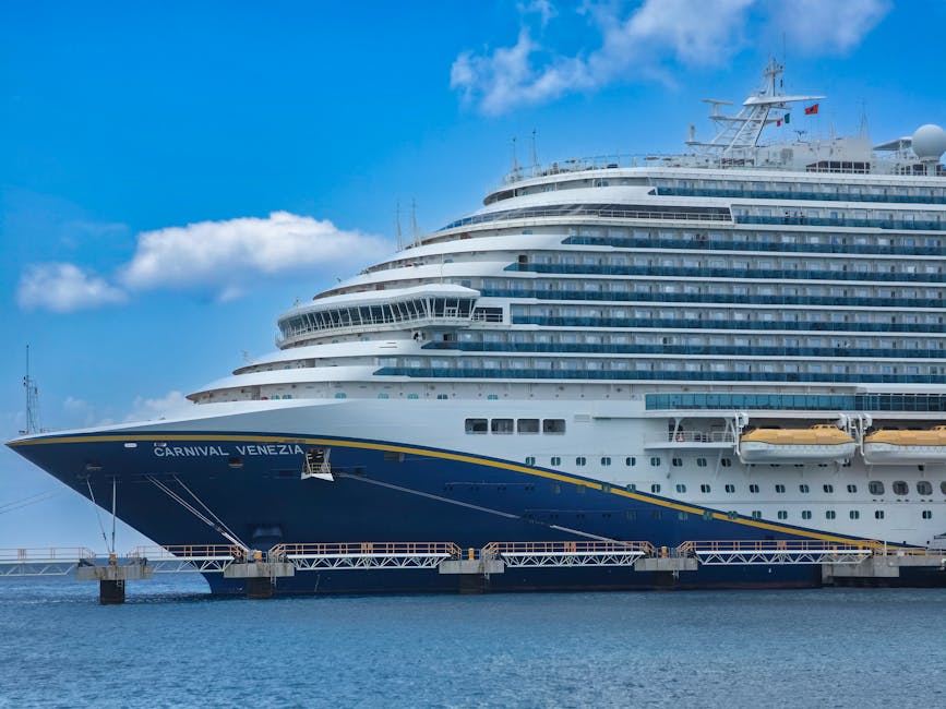 A luxury cruise ship docked under a clear, blue sky, ready for its next voyage.