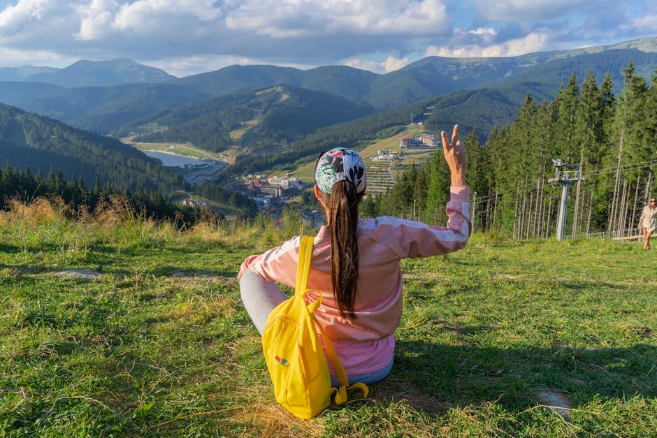 A woman enjoys a peaceful moment with a view of Bukovel's stunning mountainous landscape, Ukraine.